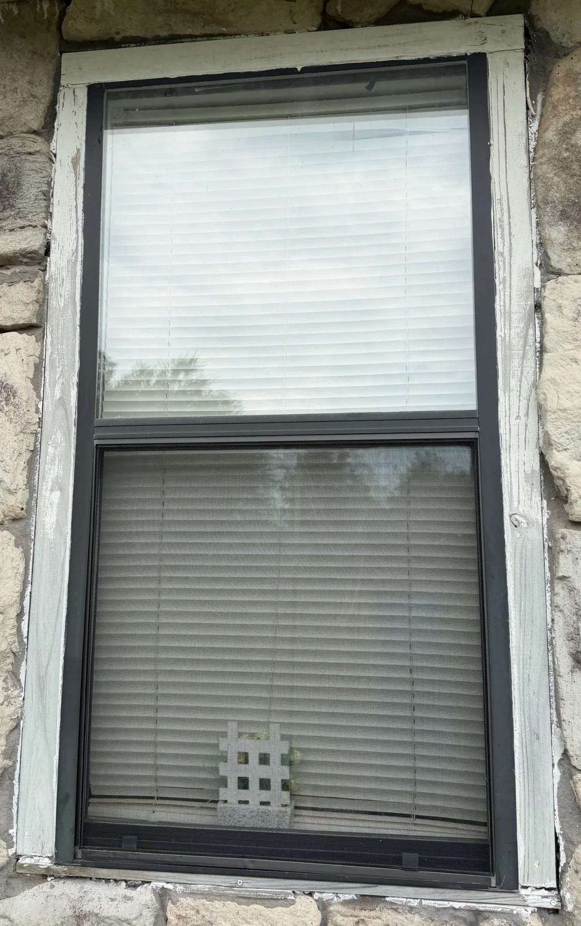Church window and surrounding frame needing repair